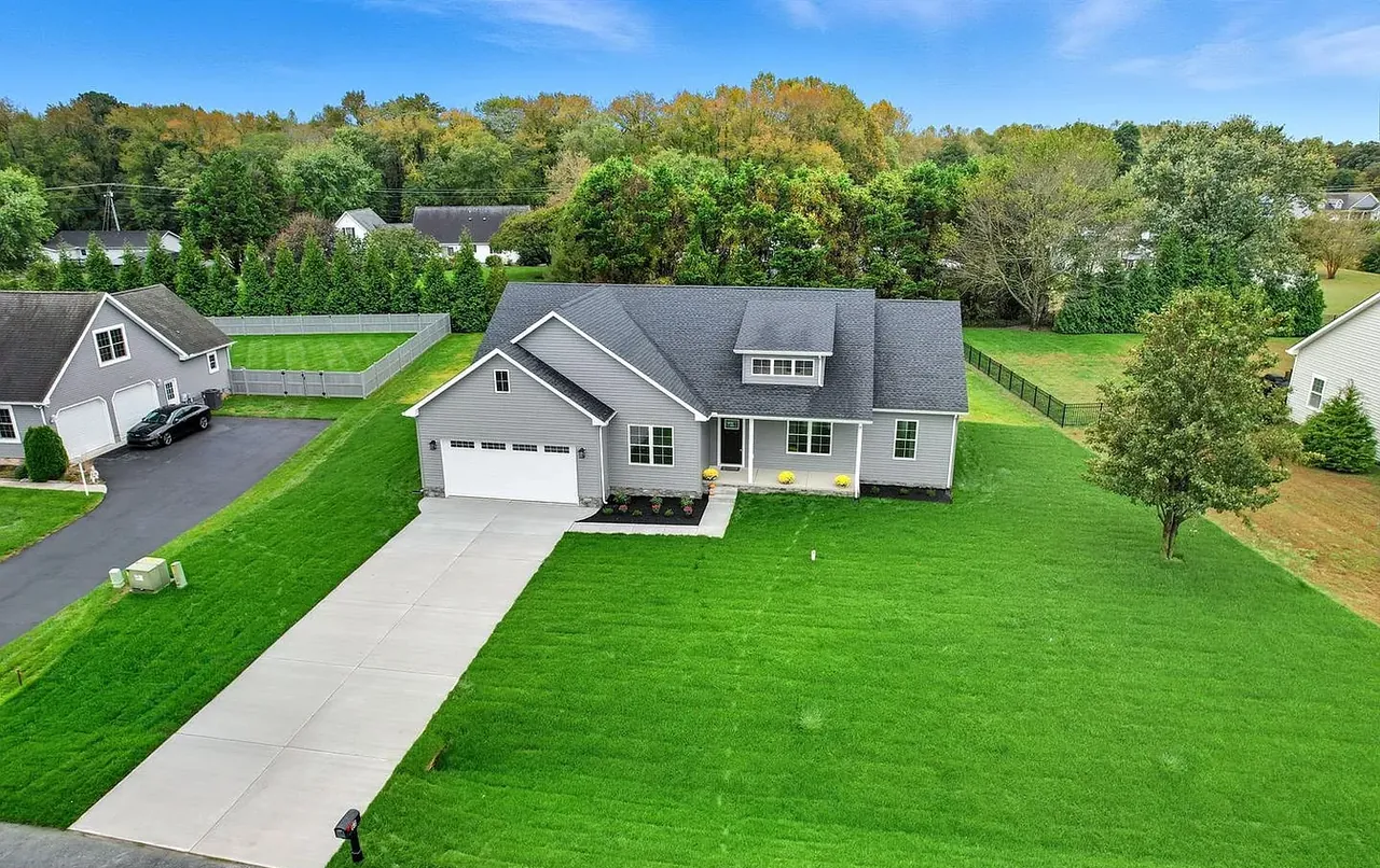 Aerial view of a completed new home on a landscaped lot