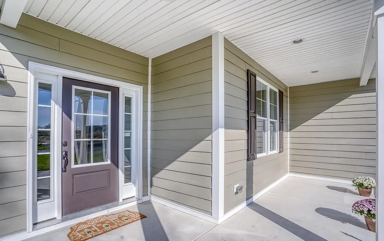 Covered porch detail with beadboard ceiling and glazed entry door