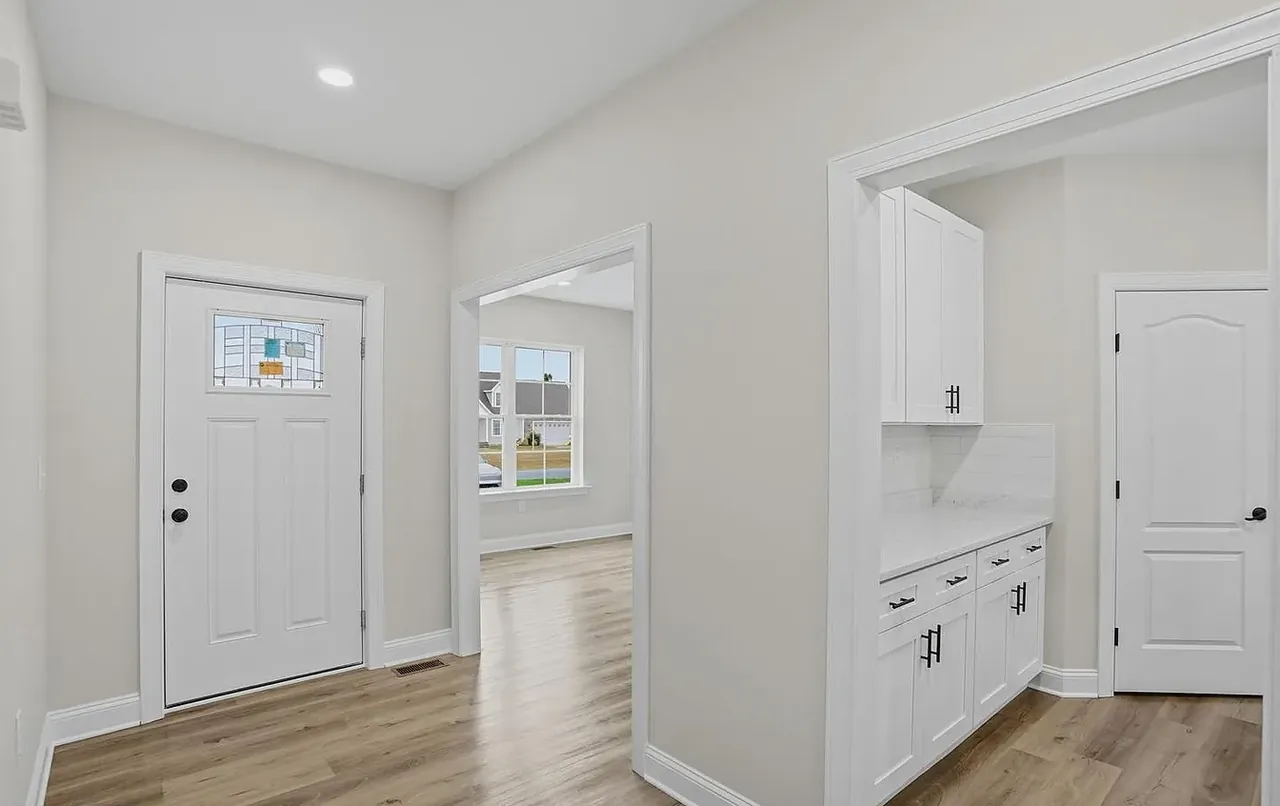 Entry hall with glazed front door looking through to the kitchen