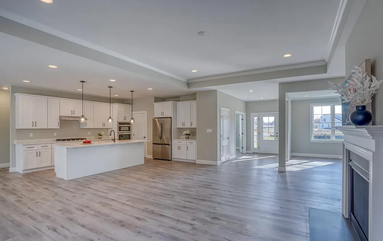 Great room opening onto the kitchen with luxury vinyl plank flooring