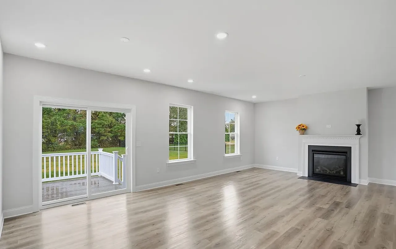 Great room with corner fireplace and sliding doors to the rear deck