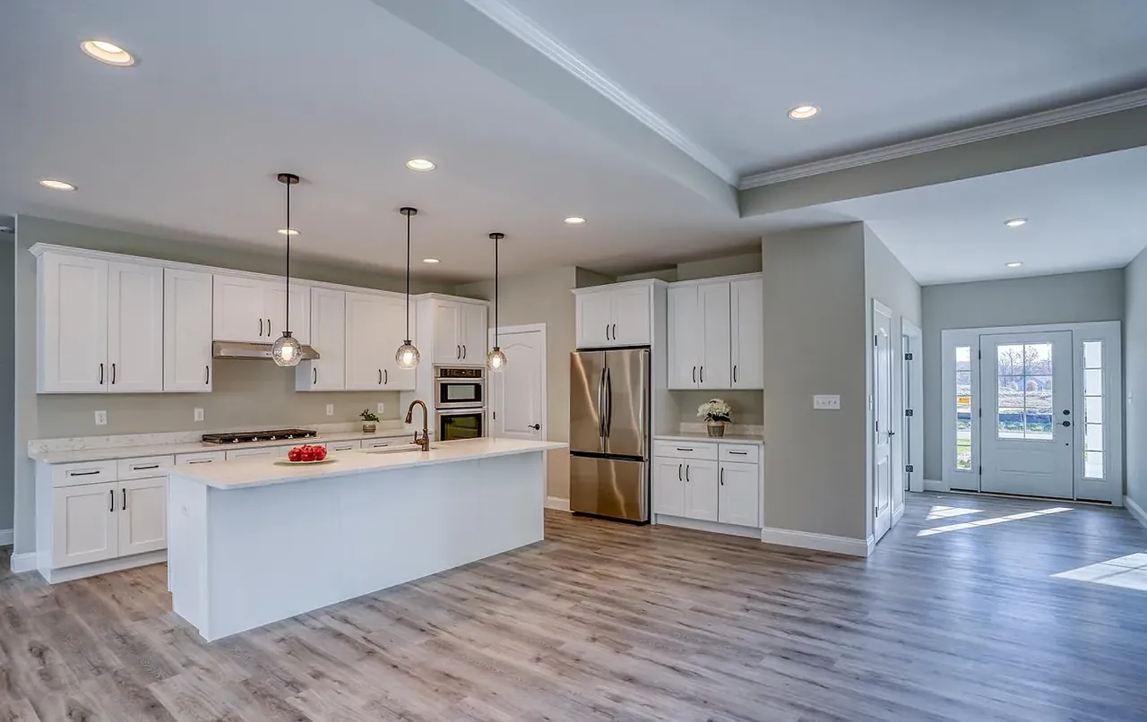 White shaker kitchen with large island and stainless appliances