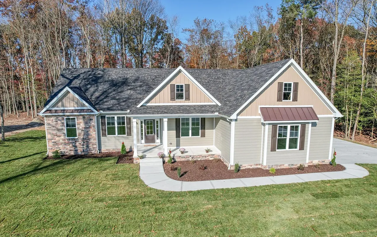Front elevation of a stone-and-siding craftsman home with a standing-seam porch roof